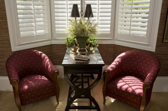 Custom shutters installed in a sophisticated Richmond Hill, Ontario, living room with classic furniture and decor.