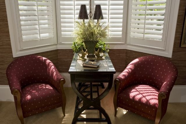 Custom shutters installed in a sophisticated Richmond Hill, Ontario, living room with classic furniture and decor.