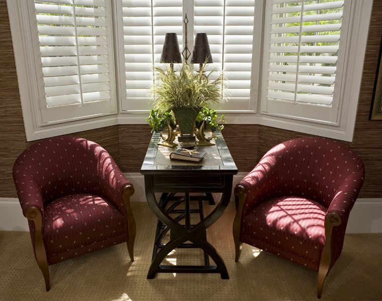 Custom shutters installed in a sophisticated Richmond Hill, Ontario, living room with classic furniture and decor.